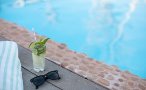 Gift card image a cocktail and sunglasses by the edge of the pool