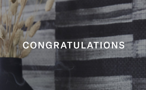 Gift card image of flowers set against a black and white backdrop with the text “Congratulations”