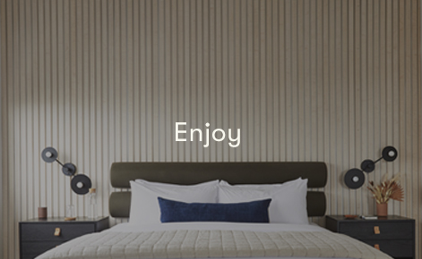 Gift card image of the hotel room bed with the text “Enjoy”