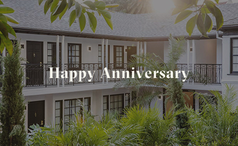 Gift card image of the exterior of the hotel rooms with the text “Happy Anniversary”