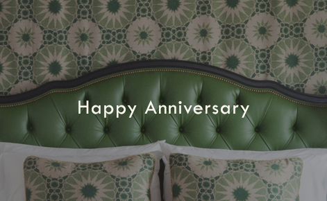 Gift card image of hotel room bed with the text “Happy Anniversary” 